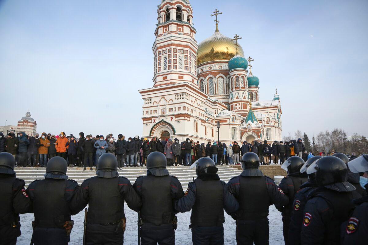 Police stand guard during a protest against the jailing of opposition leader Alexei Navalny in the Siberian city of Omsk, Russia, on Jan. 23, 2021. (AP Photo)