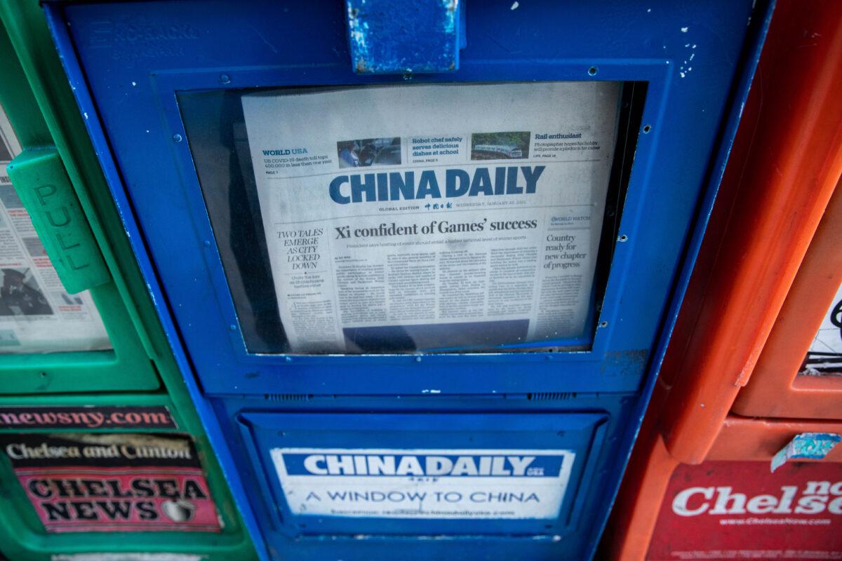 A China Daily newspaper box is with other free daily papers in New York on Jan. 20, 2021. (Chung I Ho/The Epoch Times)