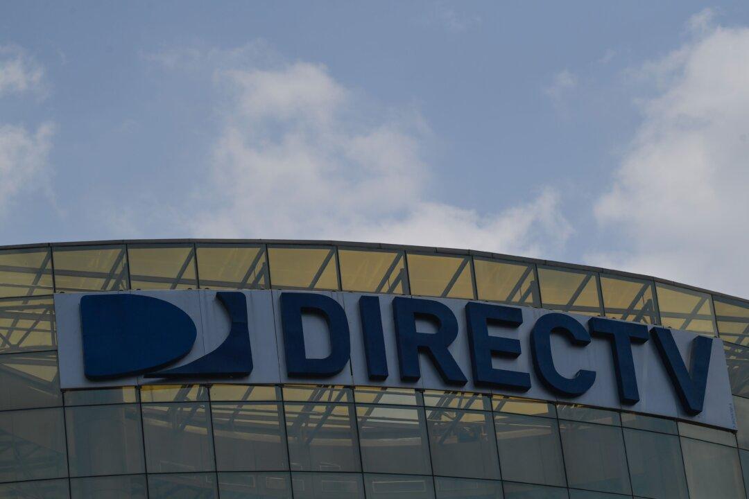 AT&T Takes $15.5 Billion Charge on DirecTV, Adds More Phone Customers