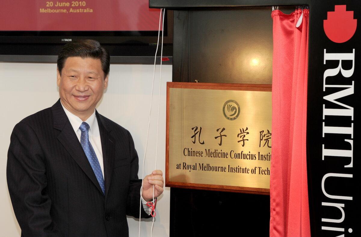Then-Chinese vice chair Xi Jinping unveils a plaque at the opening of Australia's first Chinese Medicine Confucius Institute at the RMIT University in Melbourne on June 20, 2010. (William West/AFP via Getty Images)