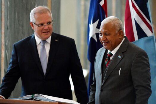 Australia's Prime Minister Scott Morrison (L) invites his Fijian counterpart, Frank Bainimarama, to sign a visitors book at Parliament House in Canberra, Australia, on Sept. 16, 2019.(Mick Tsikas/AFP via Getty Images)