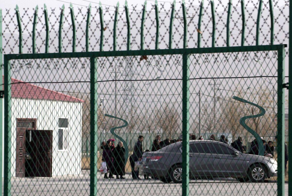 People line up inside the Artux City Vocational Skills Education Training Service Center which has been revealed to be a forced indoctrination camp, in Artux in western China's Xinjiang region on Dec. 3, 2018. (Ng Han Guan/File/AP Photo)