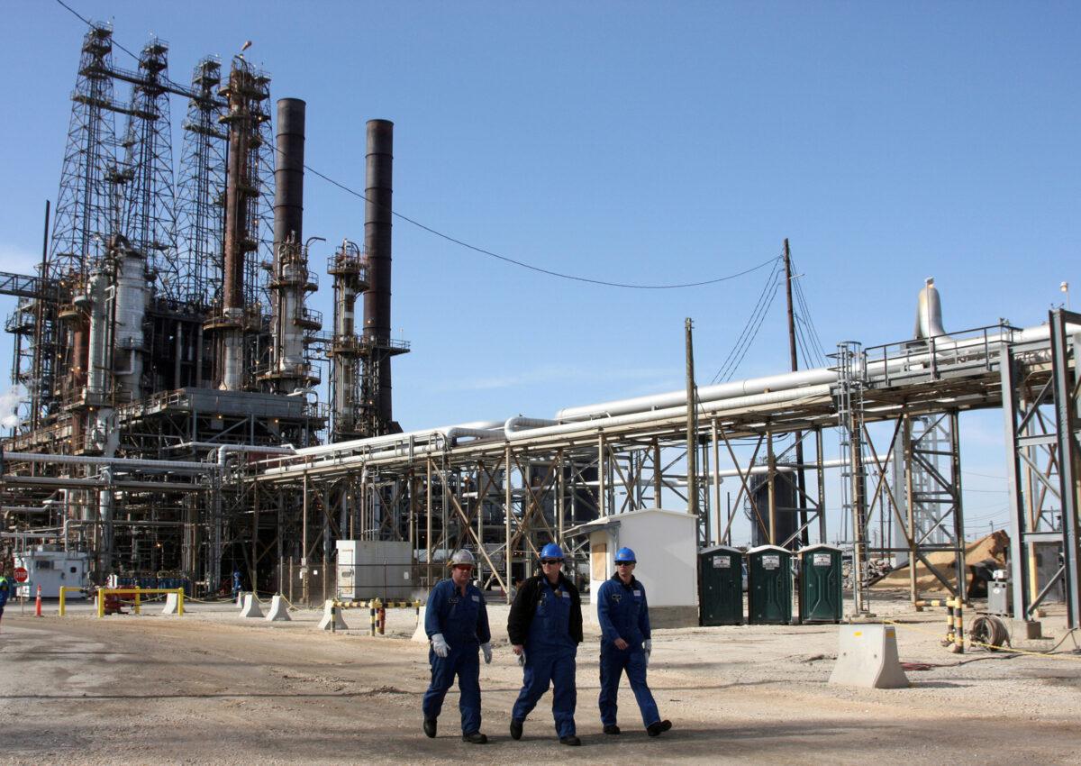 Refinery workers walk inside the LyondellBasell oil refinery in Houston, Texas, on March 6, 2013. (Donna Carson/Reuters)