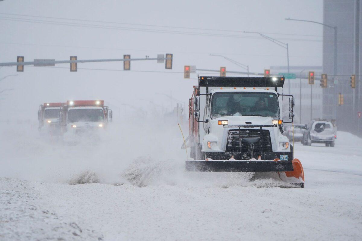 Snowplows works to clear the road during a winter storm Sunday, Feb. 14, 2021, in Oklahoma City. Snow and ice blanketed large swaths of the U.S. on Sunday, prompting canceled flights, making driving perilous and reaching into areas as far south as Texas’ Gulf Coast, where snow and sleet were expected overnight. (AP Photo/Sue Ogrocki)