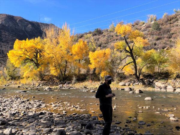 A masked traveler enjoys nature near a Colorado RV park during a pandemic trip. (Courtesy of Bill Neely)