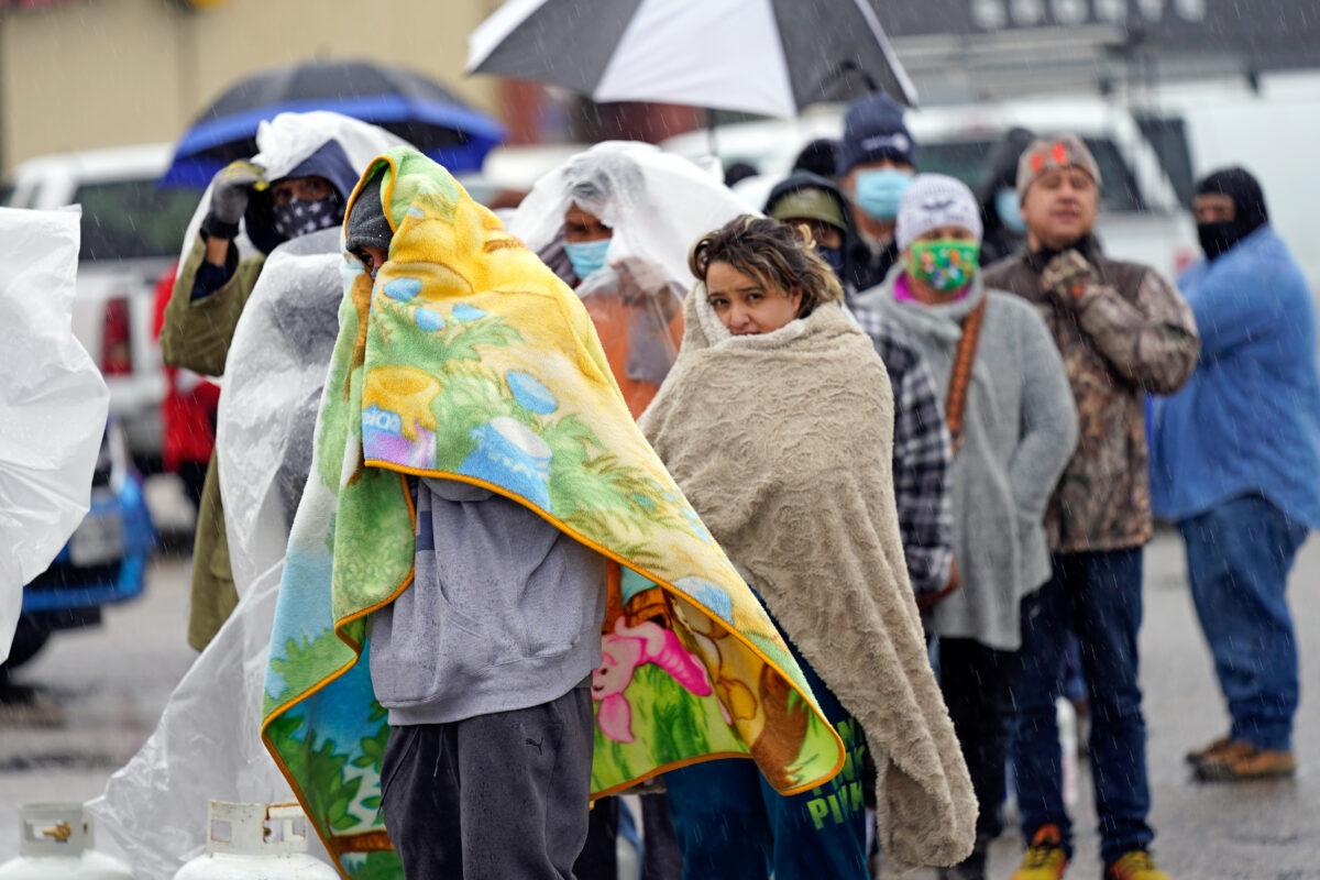 People wait in line to fill propane tanks in Houston, Texas, on Feb. 17, 2021. Millions in Texas still had no power after a historic snowfall and single-digit temperatures created a surge of demand for electricity to warm up homes unaccustomed to such extreme lows, buckling the state's power grid and causing widespread blackouts. (David J. Phillip/AP Photo)