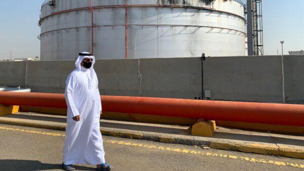 A man, mask-clad due to the COVID-19 pandemic, walks past a damaged silo at the Saudi Aramco oil facility in Saudi Arabia's Red Sea city of Jeddah on Nov. 24, 2020. (Fayez Nureldine/AFP via Getty Images)