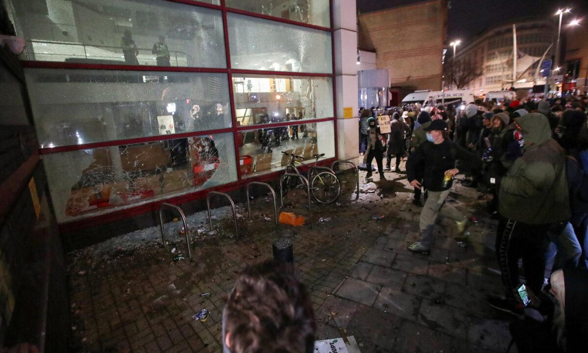 Demonstrators smash windows of a police station during a protest against a new proposed policing bill, in Bristol, Britain, on March 21, 2021. (Peter Cziborra/Reuters)