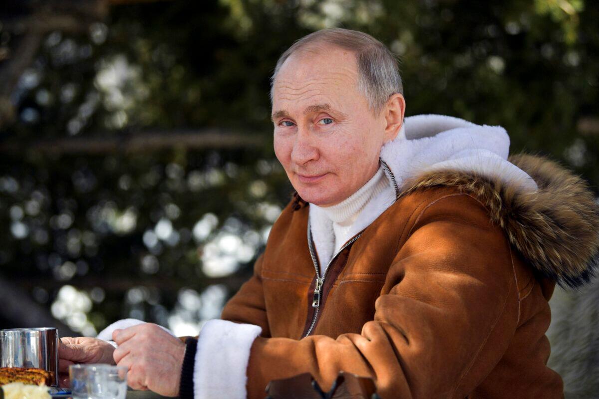 In this photograph made available on March 21, 2021, Russian President Vladimir Putin looks at a photographer in a taiga forest in Russia's Siberian region. (Alexei Druzhinin, Sputnik, Kremlin Pool Photo via AP)