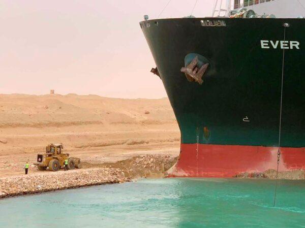 A cargo ship, named the Ever Given, sits with its bow stuck into the wall in Egypt’s Suez Canal, on March 24, 2021. (Suez Canal Authority via AP)