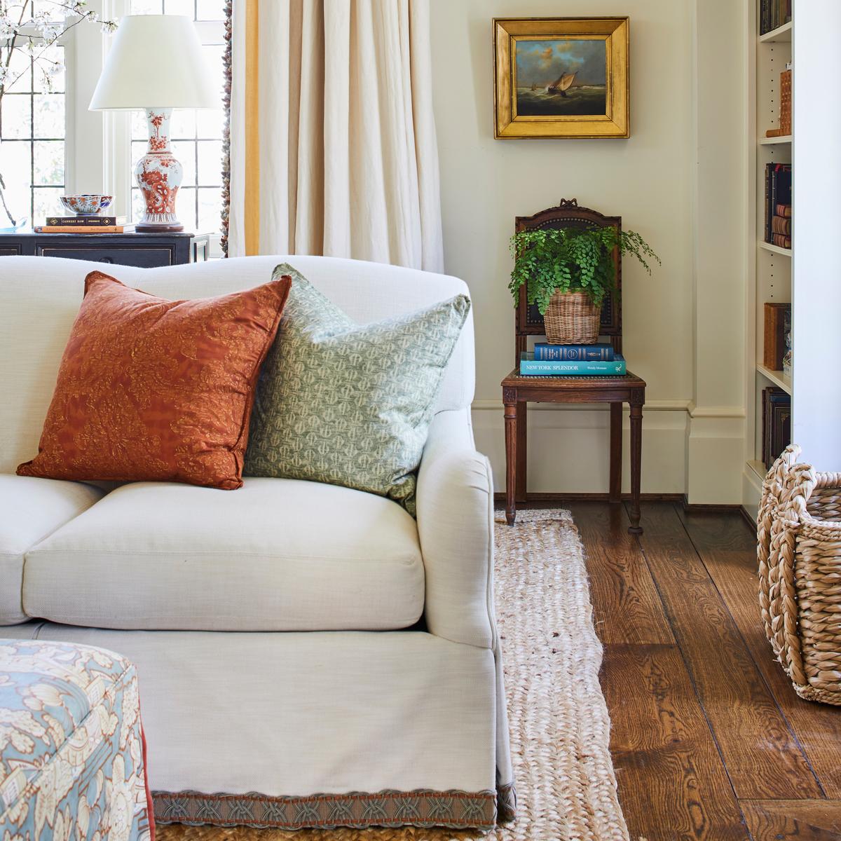 A pair of persimmon-and-white chinoiserie vase lamps provided the starting point for the great room’s effortless-looking assemblage of patterns, colors, and textures that softly accent neutrals. (Laurey Glenn)