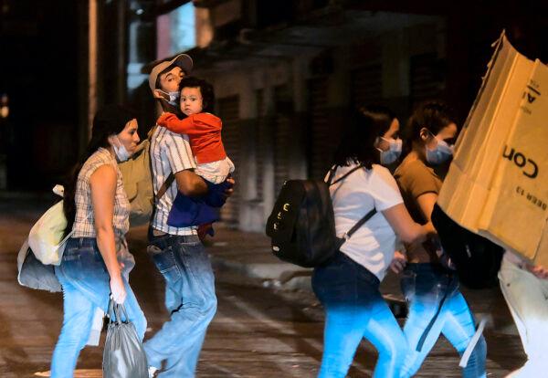 Migrants begin walking in a caravan on their way to the United States, in San Pedro Sula, Honduras, on March 30, 2021. (Wendell Escoto/AFP via Getty Images)