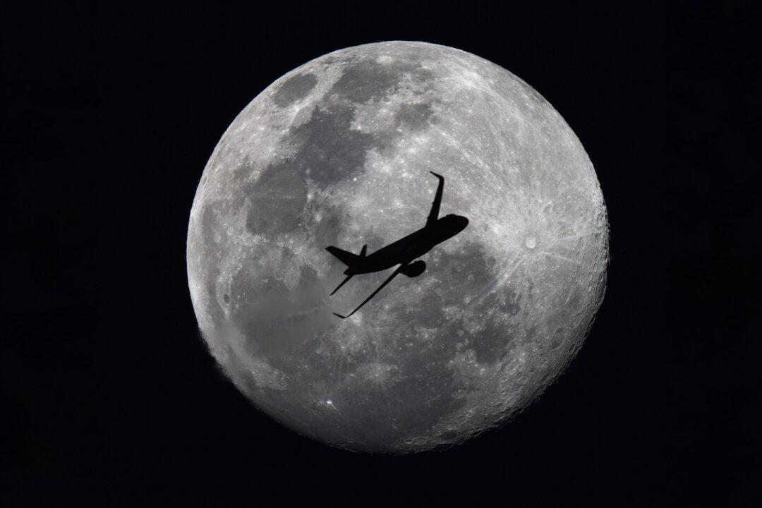Photographer Shooting Full Moon Accidentally Snaps Passenger Jet Flying Across Silvery Lunar Sphere