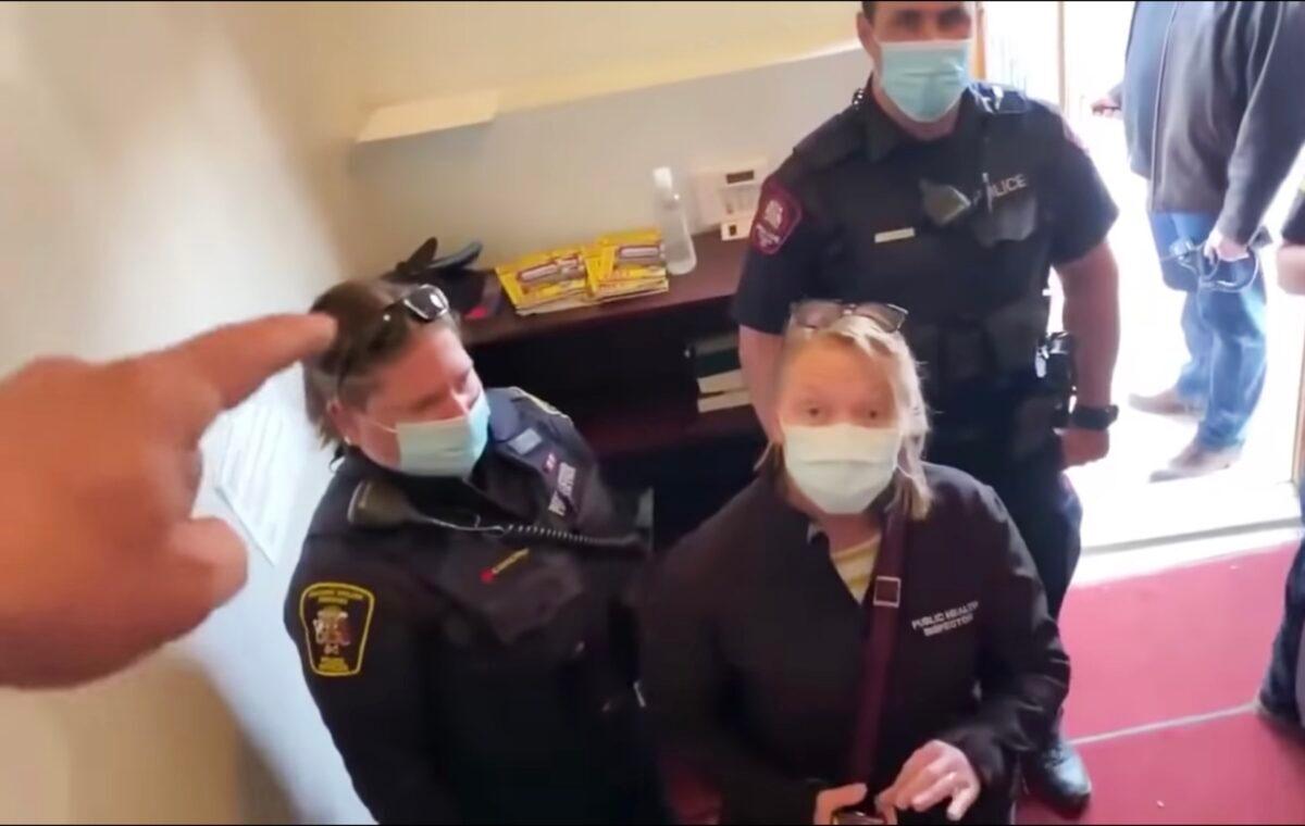 Pastor Artur Pawlowski drives police and public health officials on a COVID-19 check out of the Fortress (Cave) of Adullam Church in Calgary, Canada, on Saturday, April 3, 2021. (Screenshot Youtube via The Epoch Times)