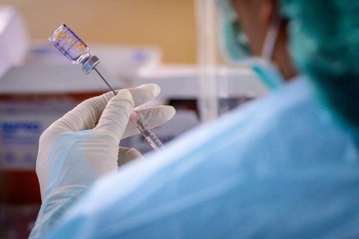 A health worker prepares to administer the COVID-19 CoronaVac vaccine, developed by China's Sinovac firm, at a makeshift clinic at Saeng Thip sports ground in Bangkok, Thailand on April 7, 2021. (Mladen Antonov/AFP via Getty Images)