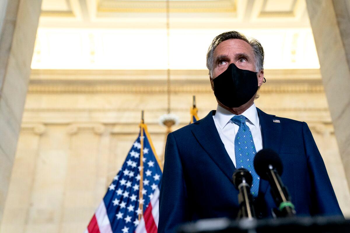 Sen. Mitt Romney (R-Utah) speaks to reporters in Washington on April 13, 2021. (Stefani Reynolds/Getty Images)