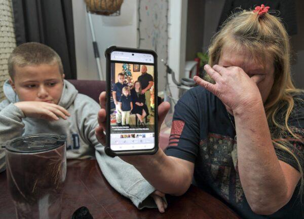 Darra Ann Morales shows a photo of her son Chaz Morales, with Chaz Jr., 10, at left, at the family home in Slidell, La., on April 14, 2021. (Max Becherer/The Times-Picayune/The New Orleans Advocate via AP)