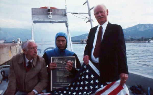 (L to R) Commandant Philippe Tailliez, a pioneer of diving; marine biologist John Christopher Fine; and former 2nd Lt. Armand C. Sedgeley travel by boat to the site of a sunken B-17 bomber for a memorial ceremony. (Courtesy of John Christopher Fine)