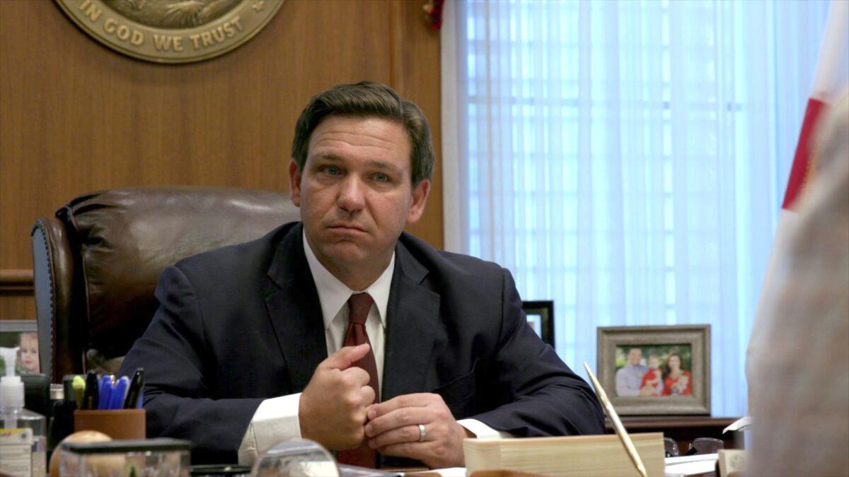 Floridа Gov. Ron DeSantis listens to a report from a member of his administration during a meeting at the governor's office in Tallahassee, Fla., on April 1, 2021. (Screenshot/Epoch Times)