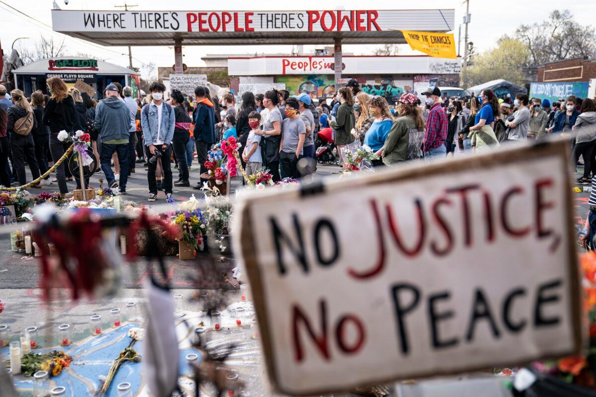 Demonstrators gather for a rally in memory of George Floyd and Daunte Wright outside Cup Foods in Minneapolis, Minn., on April 18, 2021. (John Minchillo/AP Photo)
