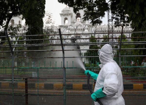 Members of disaster response force spray disinfectants as a precautionary measure against COVID-19 in Hyderabad, India, on April 19, 2021. (Mahesh Kumar A./AP Photo)