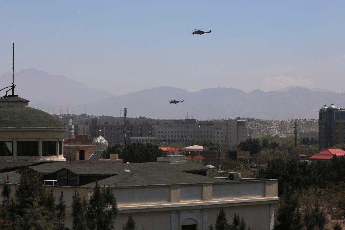 U.S. Black Hawk military helicopters fly over the city of Kabul, Afghanistan on April 19, 2021. (Rahmat Gul/AP Photo)
