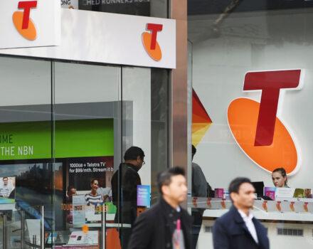 A Telstra logo is seen as a pedestrian walks outside the Telstra Melbourne headquarters in Melbourne, Australia, on June 14, 2017 (Michael Dodge/Getty Images)
