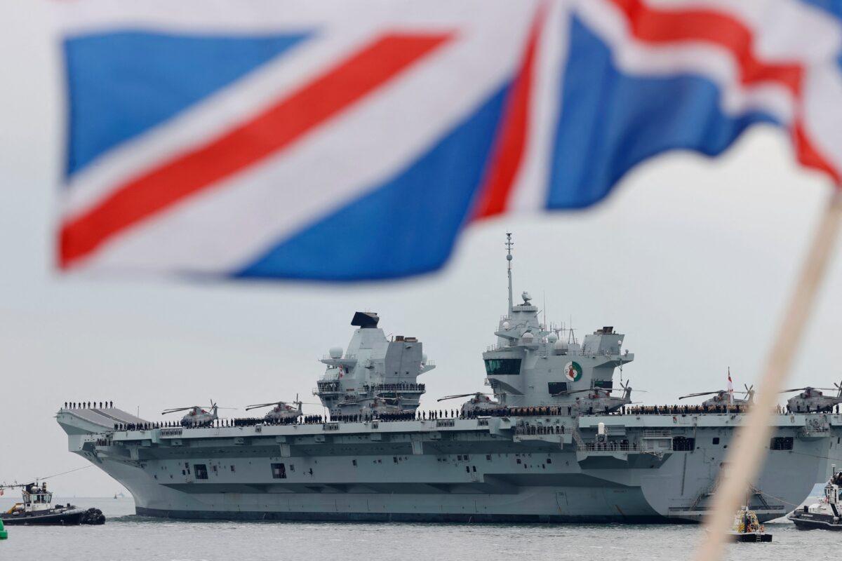 The HMS Queen Elizabeth aircraft carrier, which will head to the Indo-Pacific region for her first operational deployment, leaves Portsmouth Naval Base on the south coast of England, on May 1, 2021, (Adrian Dennis/AFP via Getty Images)