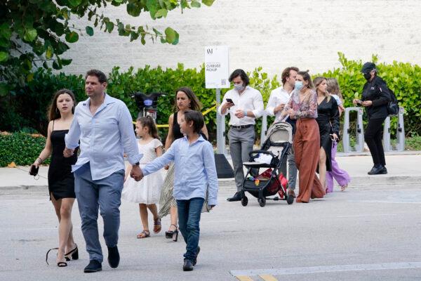 Shoppers who were hiding in stores exit the Aventura Mall after a shooting left three people injured and several suspects in custody, in Aventura, Fla., on May 8, 2021. (Marta Lavandier/AP Photo)