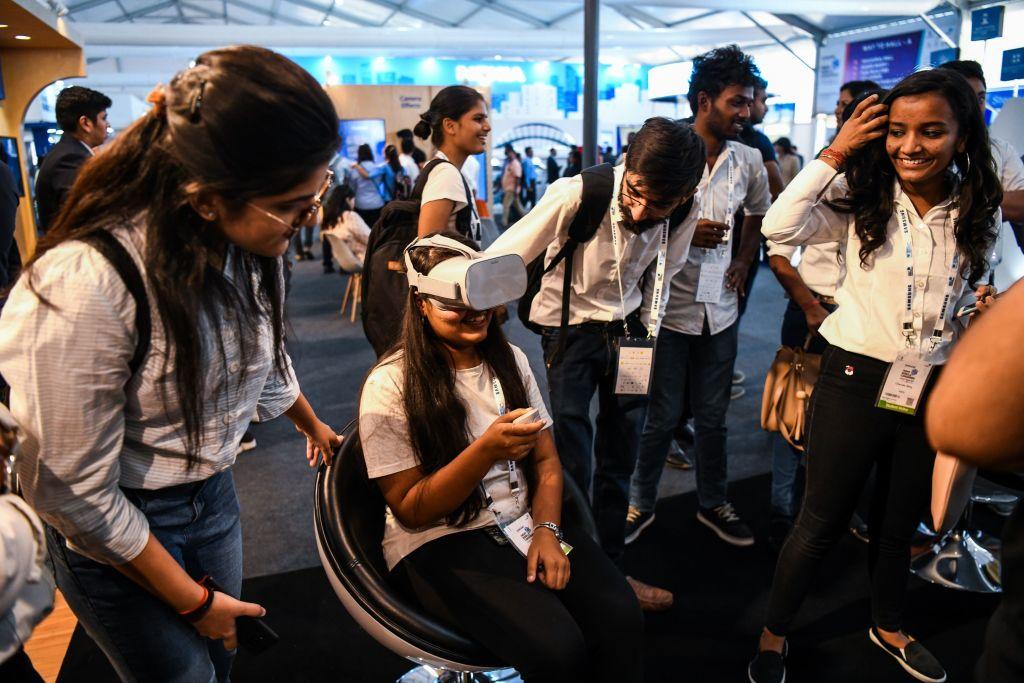 Visitors test a 5G virtual reality demonstration at the India Mobile Congress 2018 in New Delhi on Oct. 25, 2018. (Chandan Khanna/AFP via Getty Images)