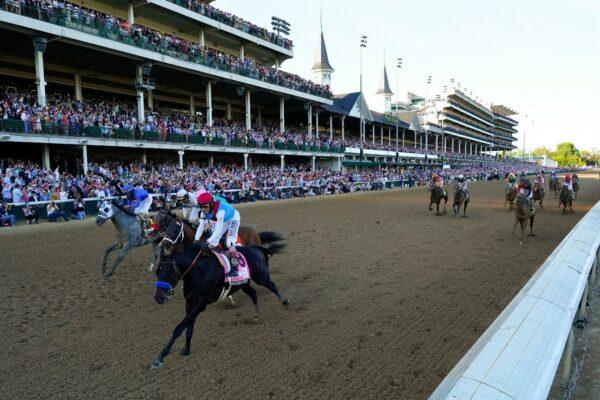 John Velazquez riding Medina Spirit leads Florent Geroux on Mandaloun, Flavien Prat riding Hot Rod Charlie and Luis Saez on Essential Quality to win the 147th running of the Kentucky Derby at Churchill Downs, in Louisville, Ky., on May 1, 2021. (Jeff Roberson/AP Photo)