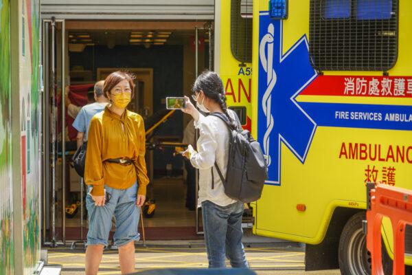 Sarah Liang, a reporter for the Hong Kong edition of The Epoch Times, stands outside the Queen Elizabeth Hospital in Hong Kong on May 11, 2021. (Adrian Yu/The Epoch Times)