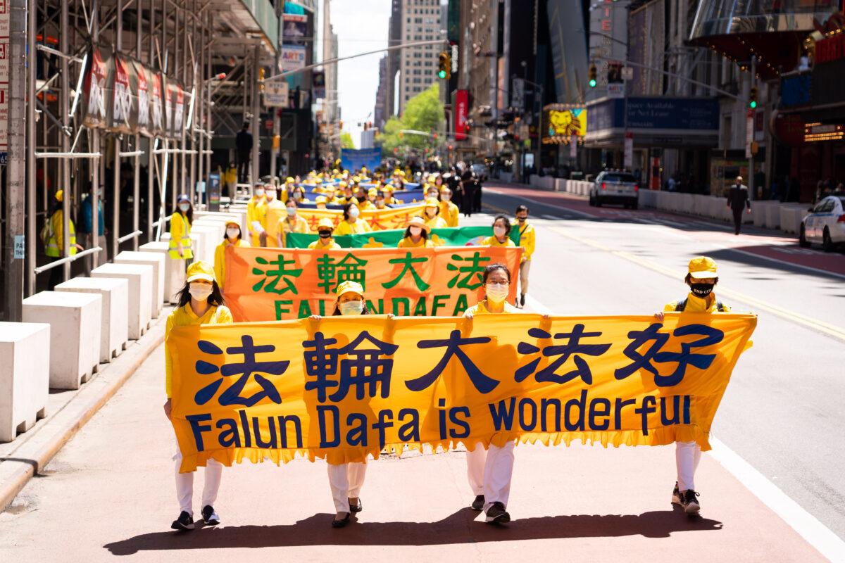 Practitioners of the spiritual discipline Falun Gong hold a parade in New York to celebrate World Falun Dafa Day and to protest the ongoing persecution of the group by the Chinese Communist Party in China, on May 13, 2021. (Larry Dai/The Epoch Times)