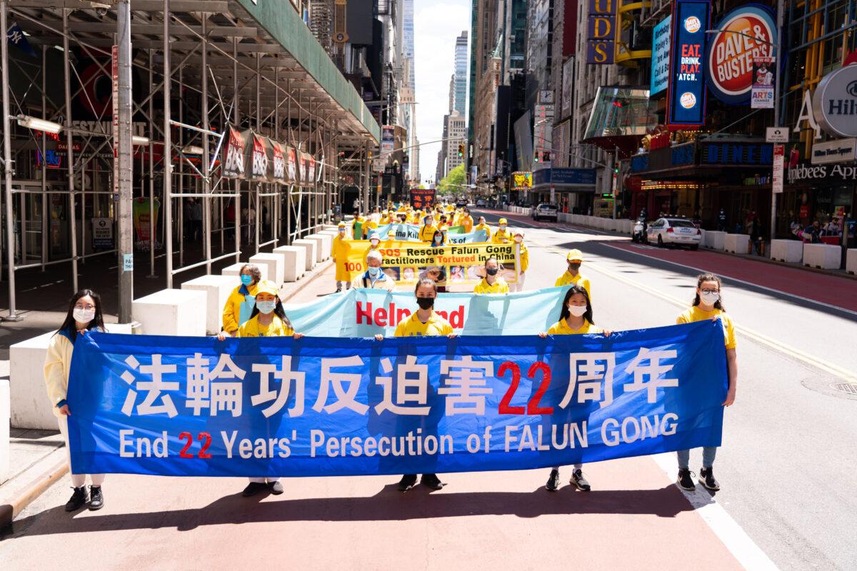 Practitioners of the spiritual discipline Falun Gong hold a parade in New York to celebrate World Falun Dafa Day and to protest the ongoing persecution of the group by the Chinese Communist Party in China, on May 13, 2021. (Larry Dai/The Epoch Times)