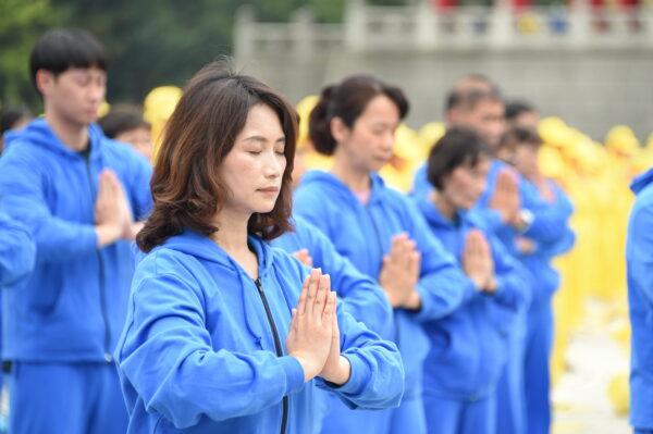 Falun Gong practitioners perform the practice's exercises at an event celebrating World Falun Dafa Day in Taipei, Taiwan, on May 1, 2021. (Sun Hsiang-yi/The Epoch Times)