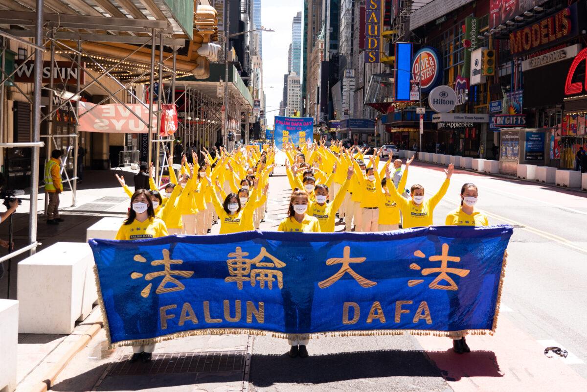 Practitioners of the spiritual discipline Falun Gong hold a parade in New York City on May 13, 2021. (Larry Dai/The Epoch Times)