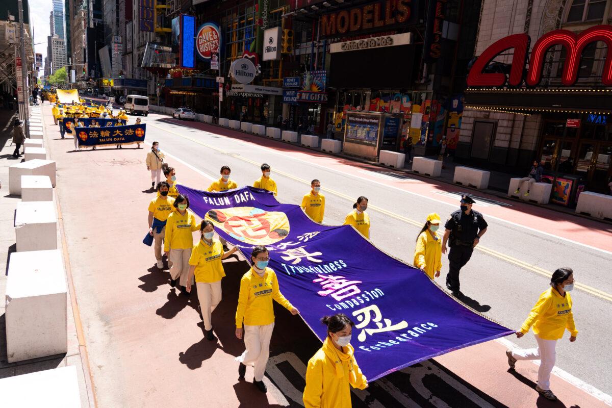 Practitioners of the spiritual discipline Falun Gong hold a parade in New York City on May 13, 2021. (Larry Dai/The Epoch Times)