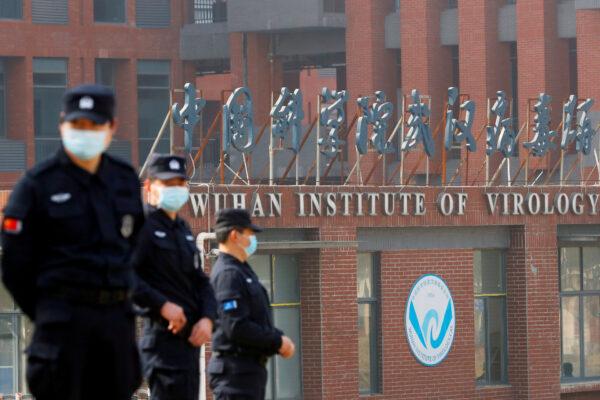 Security personnel keep watch outside the Wuhan Institute of Virology during the visit by the World Health Organization (WHO) team tasked with investigating the origins of COVID-19, in Wuhan, Hubei Province, China, on Feb. 3, 2021. (Thomas Peter/Reuters)