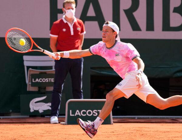 Argentina's Diego Schwartzman stretches to return the ball to Spain's Rafael Nadal during their quarterfinal match of the French Open tennis tournament at the Roland Garros stadium in Paris, France, on June 9, 2021. (Michel Euler/AP Photo)