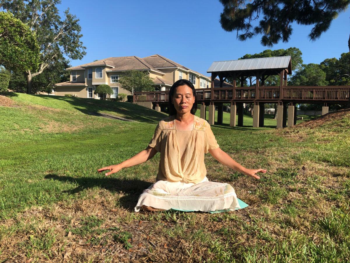 Falun Gong practitioner You Ling meditates near her home in Tampa, Fla., on June 10, 2021. (Courtesy of You Ling)