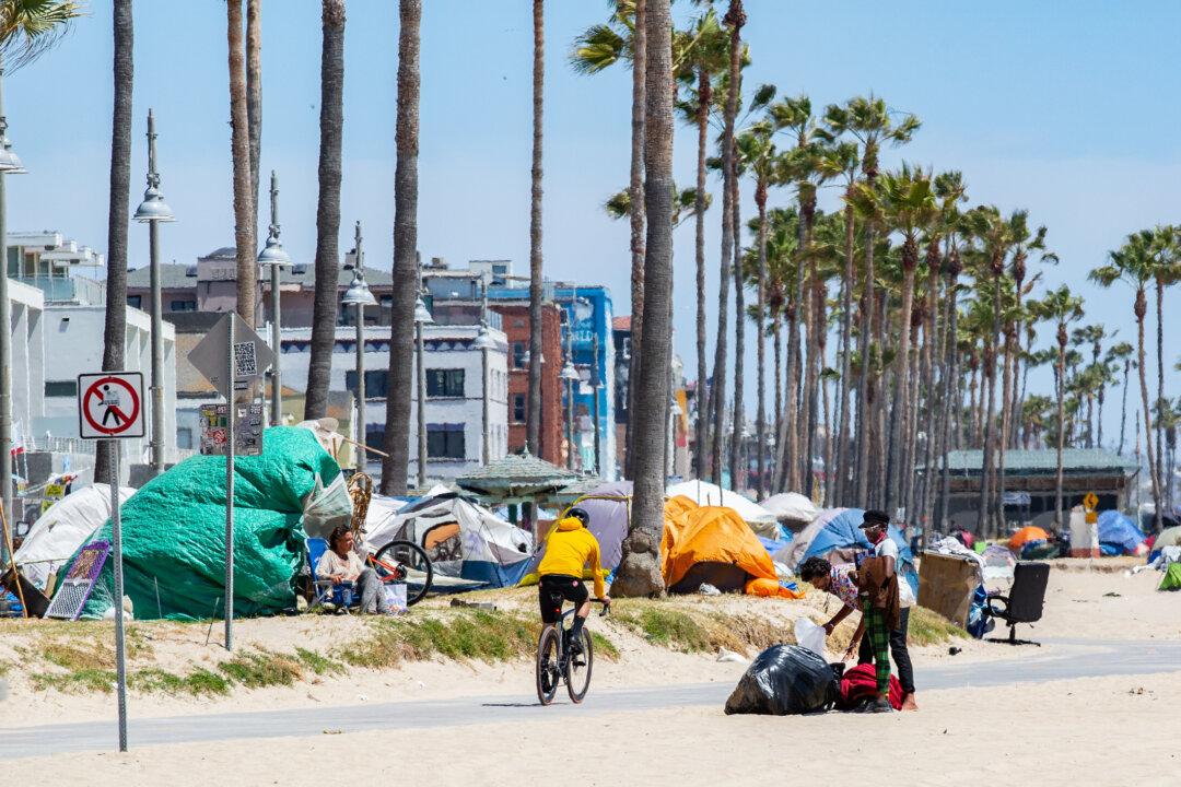 Triathlon Athletes Ride Past Homeless Encampments in Venice Beach