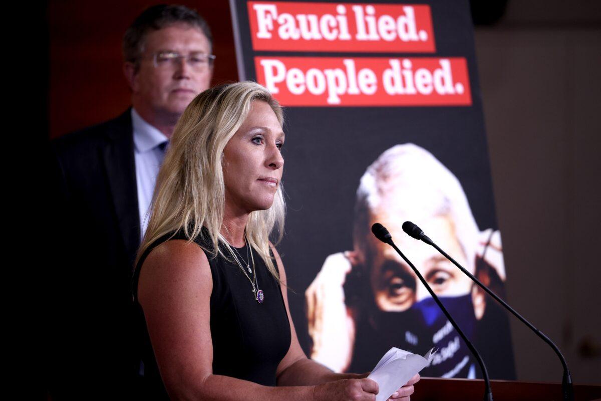 Rep. Marjorie Taylor Greene (R-Ga.) speaks at a news conference, as Rep. Thomas Massie (R-Ky.) listens, on the “Fire Fauci Act” on Capitol Hill in Washington on June 15, 2021. (Anna Moneymaker/Getty Images)