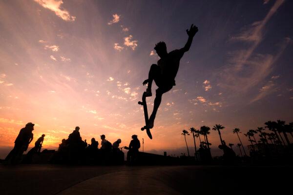 A skateboarder is silhouetted as he jumps high at the skateboard park during sunset in the Venice Beach section of Los Angeles, Calif., on June 16, 2021. (Ringo H.W. Chiu/File/AP Photo)
