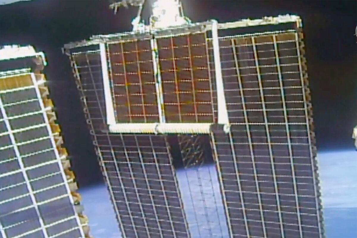 In this image taken from NASA video, a solar panel is unfolded at the International Space Station on June 20 2021. (NASA via AP)