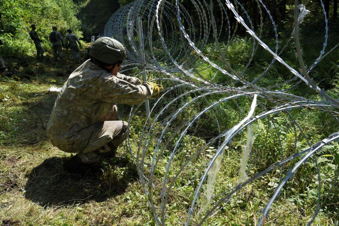 Lithuania Toughens Belarus Border With Razor Wire to Bar Migrants