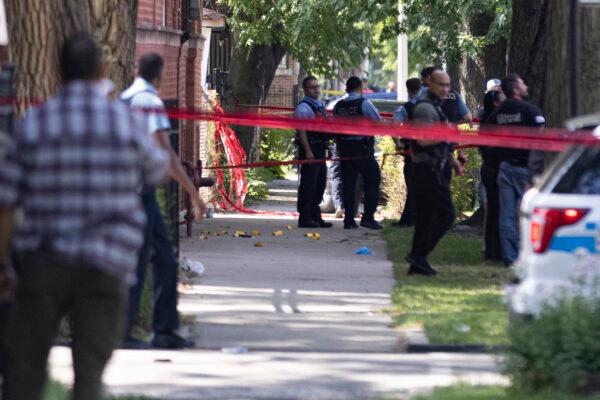 Police investigate the scene in which police opened fire during an arrest near 109 S Kilpatrick in West Garfield Park in Chicago, Ill., on July 9, 2021. (Anthony Vazquez/Chicago Sun-Times via AP)