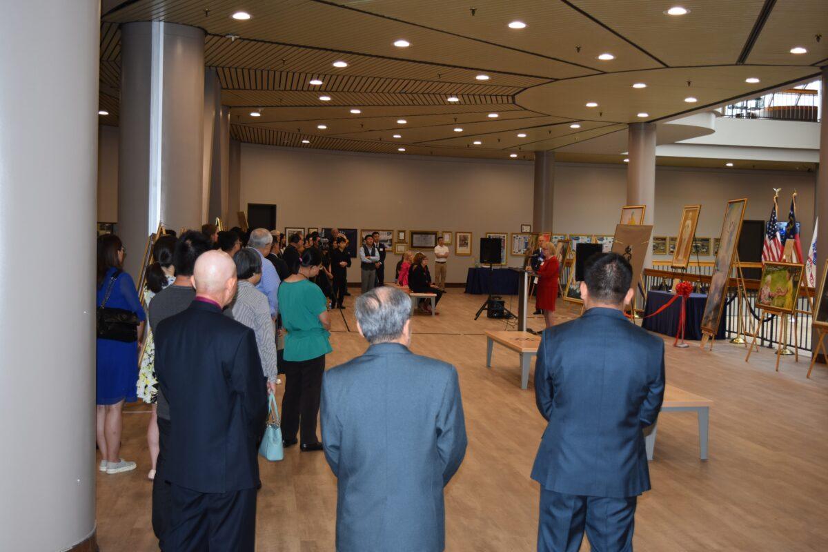 Visitors attend the opening ceremony of The Art of Zhen Shan Ren International Exhibition at the <span style="font-weight: 400;">James H. "Sloppy" Floyd Building </span>on July 8, 2021. (The Epoch Times)