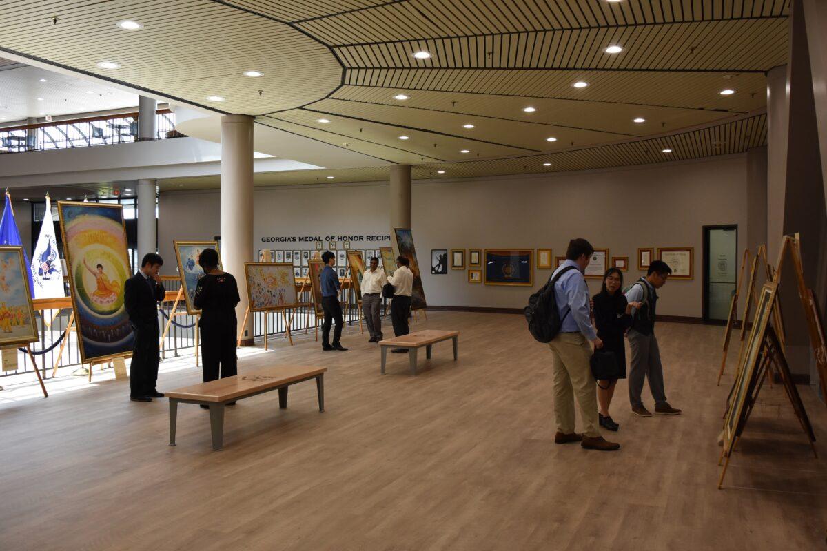 Visitors view paintings from The Art of Zhen Shan Ren International Exhibition at the James<span style="font-weight: 400;"> H. "Sloppy" Floyd Building </span>on July 8, 2021. (The Epoch Times)