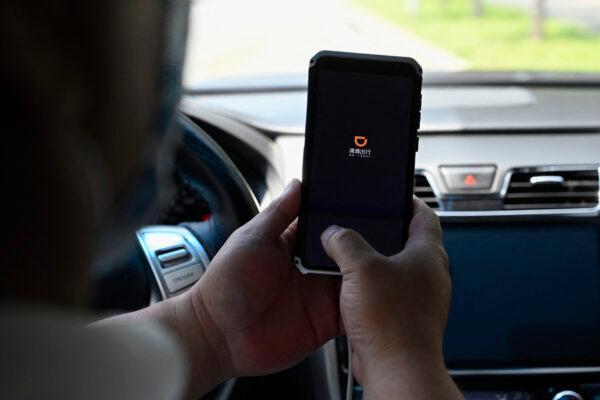 A driver opens the Didi Chuxing ride-hailing app on his smartphone in Beijing on July 2, 2021. (Jade Gao/AFP via Getty Images)