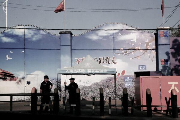 Security guards stand at the gates of what is officially known as a vocational skills education center in Huocheng County in Xinjiang Uyghur Autonomous Region, China, on Sept. 3, 2018. (Thomas Peter/Reuters)
